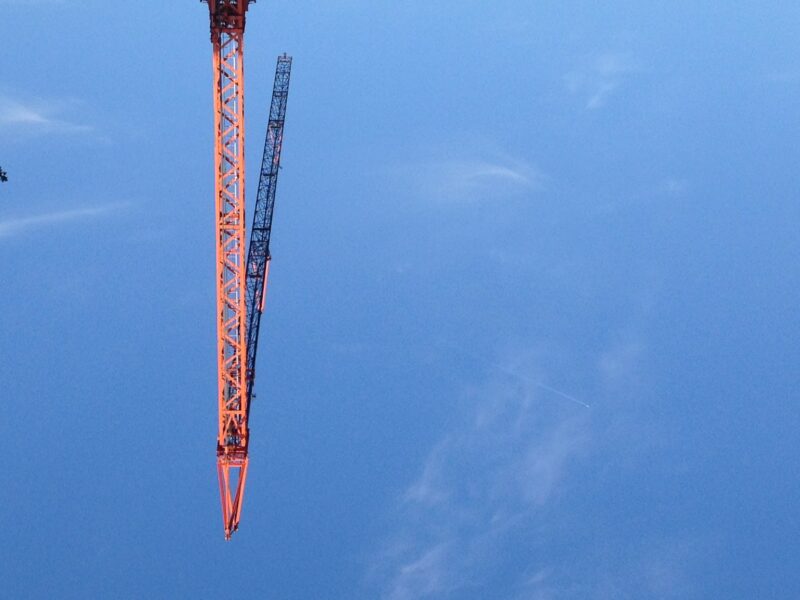 red construction crane blue skies Berlin