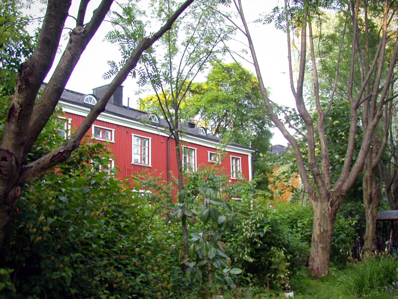 Red Wooden House in the Green